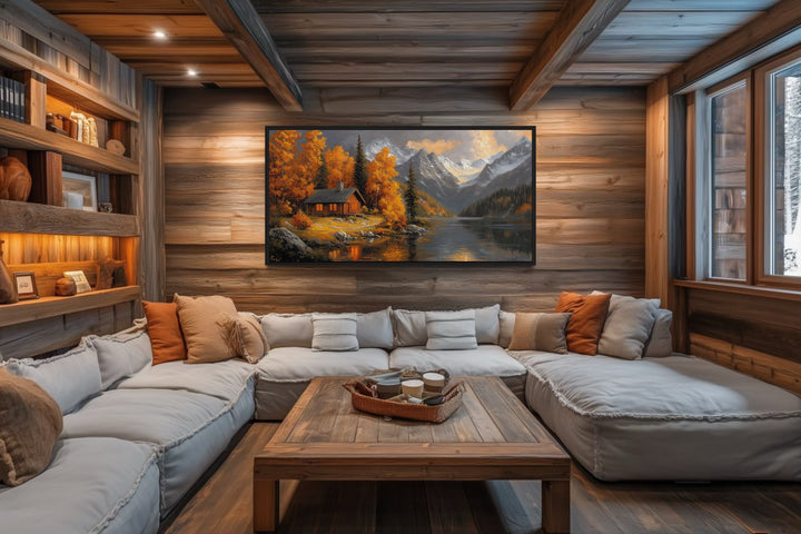 Rustic mountain cabin canvas wall art featuring autumn colors above a large sectional sofa.