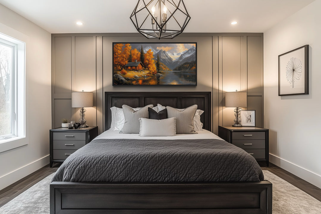 Mountain cabin wall art canvas with warm autumn colors hanging above a bed in a modern bedroom.