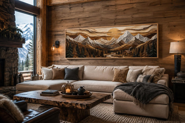 Panoramic mountain cabin canvas print above a sofa in a rustic lodge living room.
