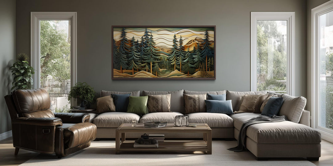 Panoramic mountain forest canvas wall art with pine trees hanging above a sofa in a rustic room.