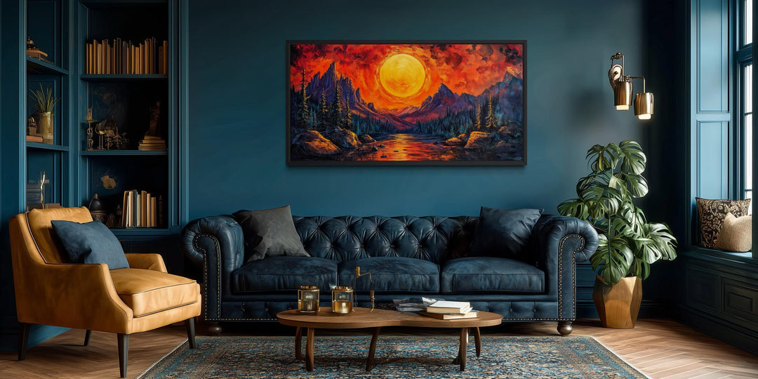 Mountain Lake Fiery Sunset canvas wall art displayed above a blue sofa in a modern living room.