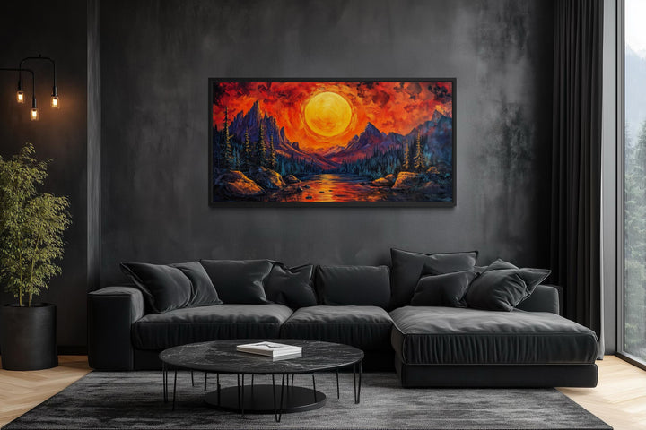 Mountain Lake Fiery Sunset canvas wall art displayed in a modern living room with a dark sofa.