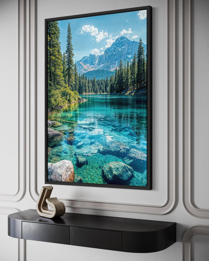 Vertical canvas wall art featuring a clear turquoise mountain lake and forest in a black frame.
