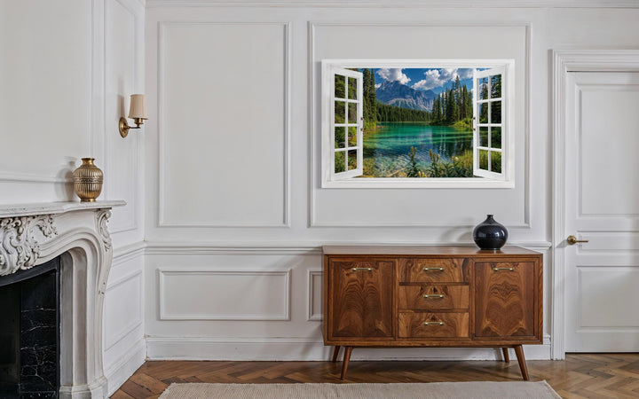 Mountain lake window view canvas wall art depicting a turquoise lake and snowy peaks.