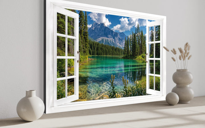 Mountain lake window view canvas wall art featuring a turquoise lake and snowy peaks.