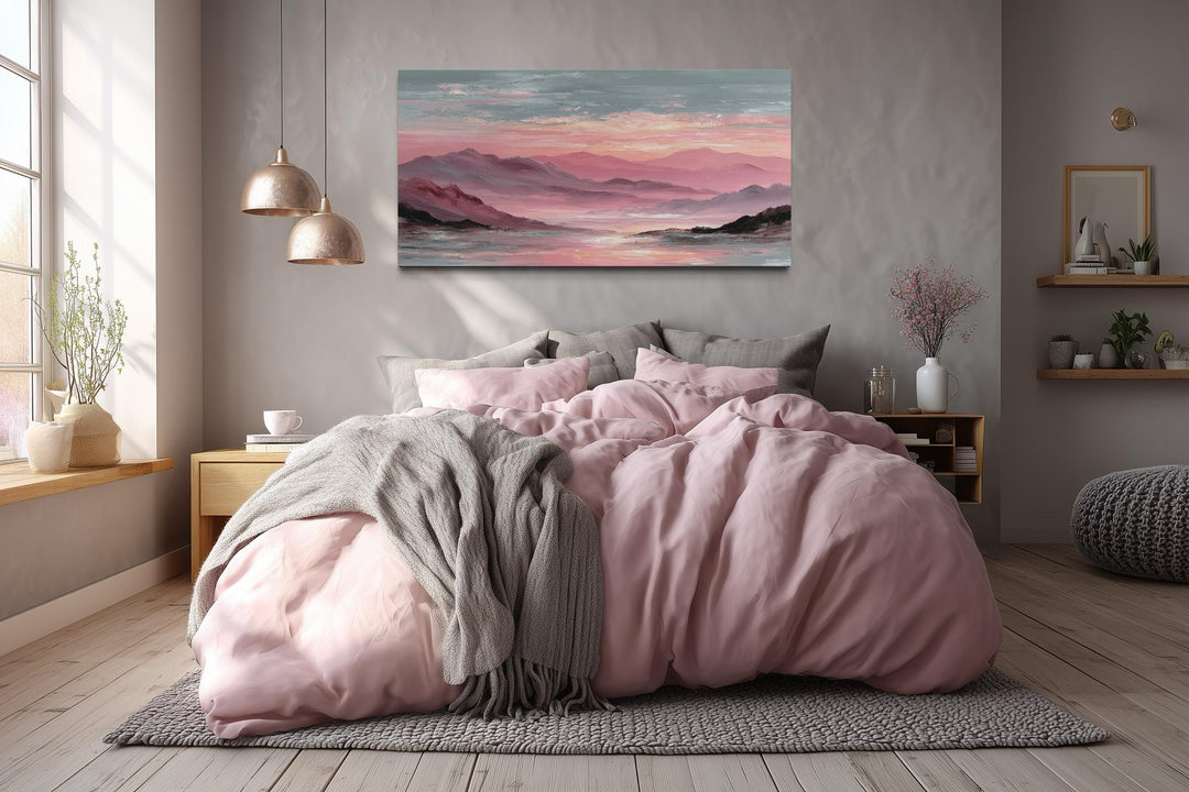 Mountain landscape canvas print featuring soft pink and grey sunset tones above a modern bed.