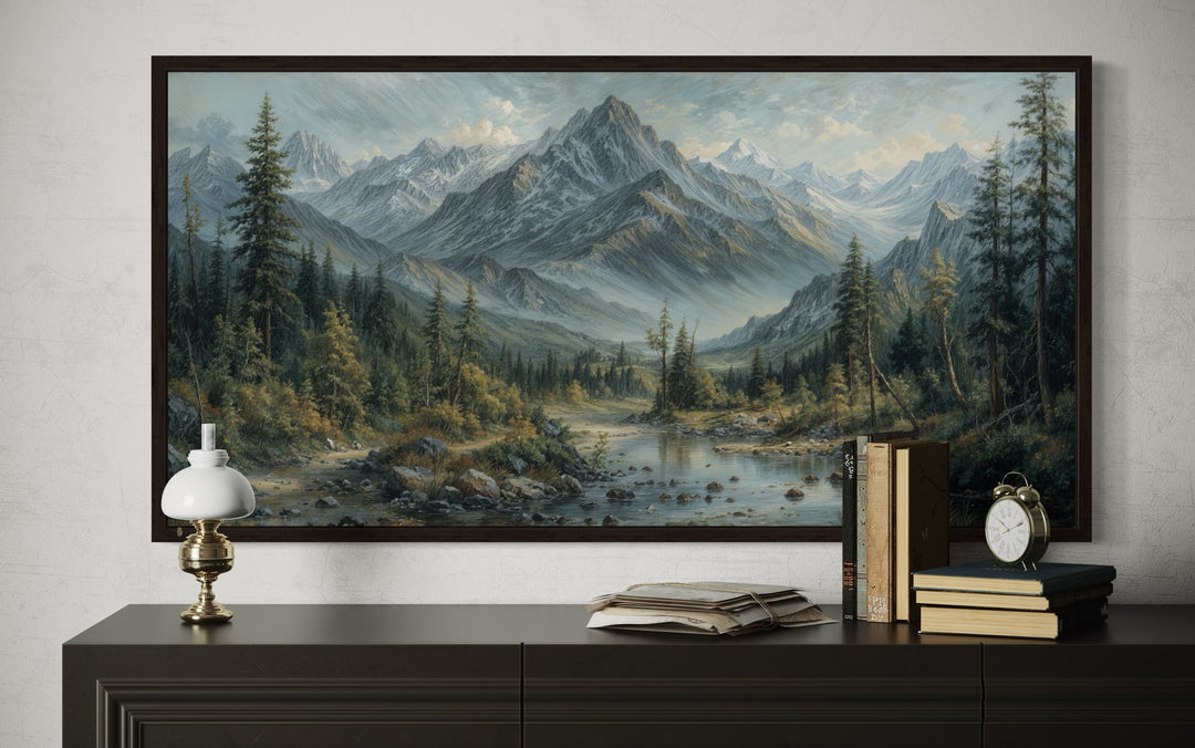 Mountain river landscape framed canvas art in an antique style, displayed above a dark console.
