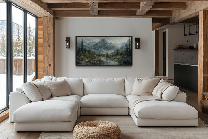 Mountain river landscape framed canvas art above a white sectional sofa in a rustic cabin living room