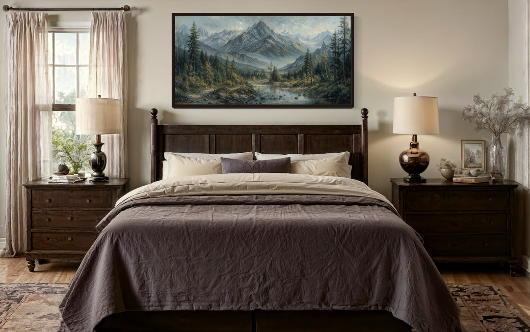 Mountain river landscape framed canvas art above a dark wood bed in a rustic bedroom.