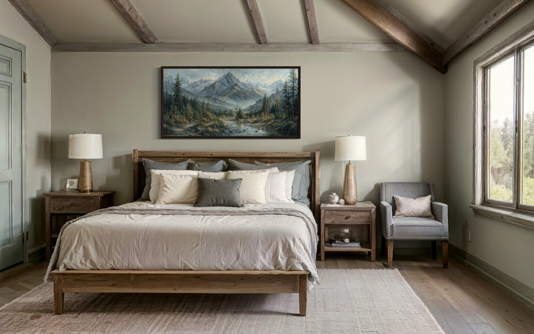 Mountain river landscape framed canvas art above a wooden bed in a rustic bedroom.