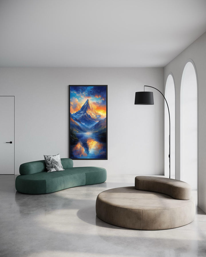 Vertical mountain sunset canvas print with blue and orange sky reflections in a modern living room.