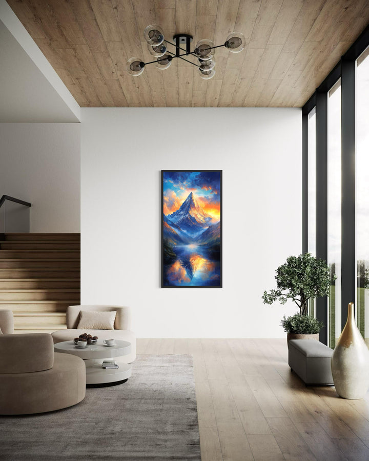 Vertical mountain sunset canvas print with blue and orange sky reflection in a modern living room.