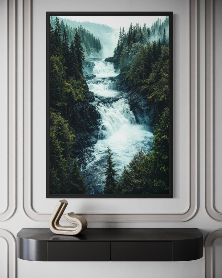 A vertical canvas print of a rushing mountain waterfall surrounded by a dense pine forest.