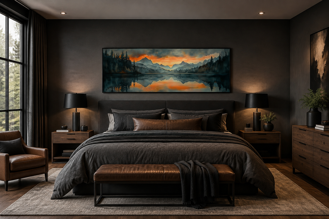 Horizontal watercolor painting of a mountain lake sunset hanging above a bed in a dark bedroom.