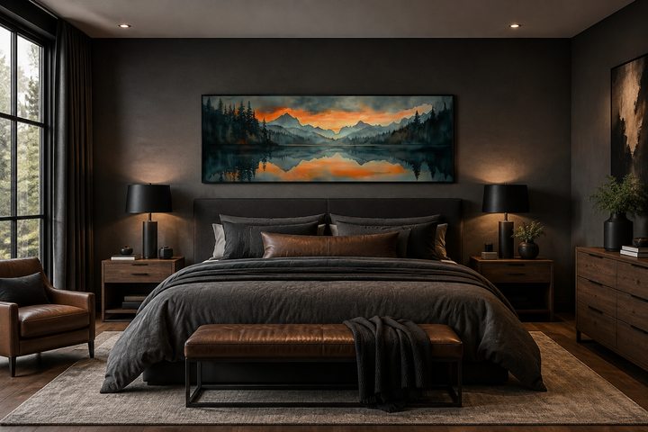 Horizontal watercolor painting of a mountain lake sunset hanging above a bed in a dark bedroom.