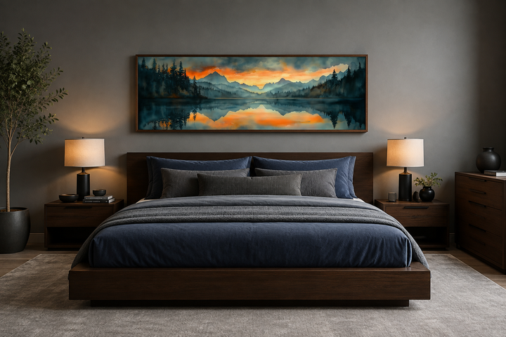 Horizontal watercolor painting of a mountain lake sunset hanging above a dark wood bed frame.