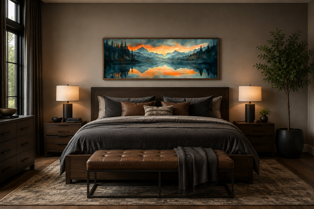 Mountain lake sunset watercolor landscape wall art hanging above a bed in a modern bedroom.
