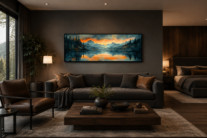 Horizontal watercolor painting of a mountain lake sunset above a sofa in a modern living room.