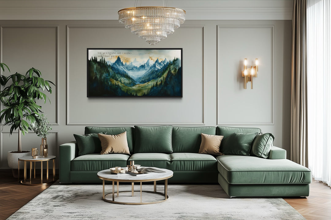 Framed mountain landscape wall art with inspirational quote above a green sectional sofa.