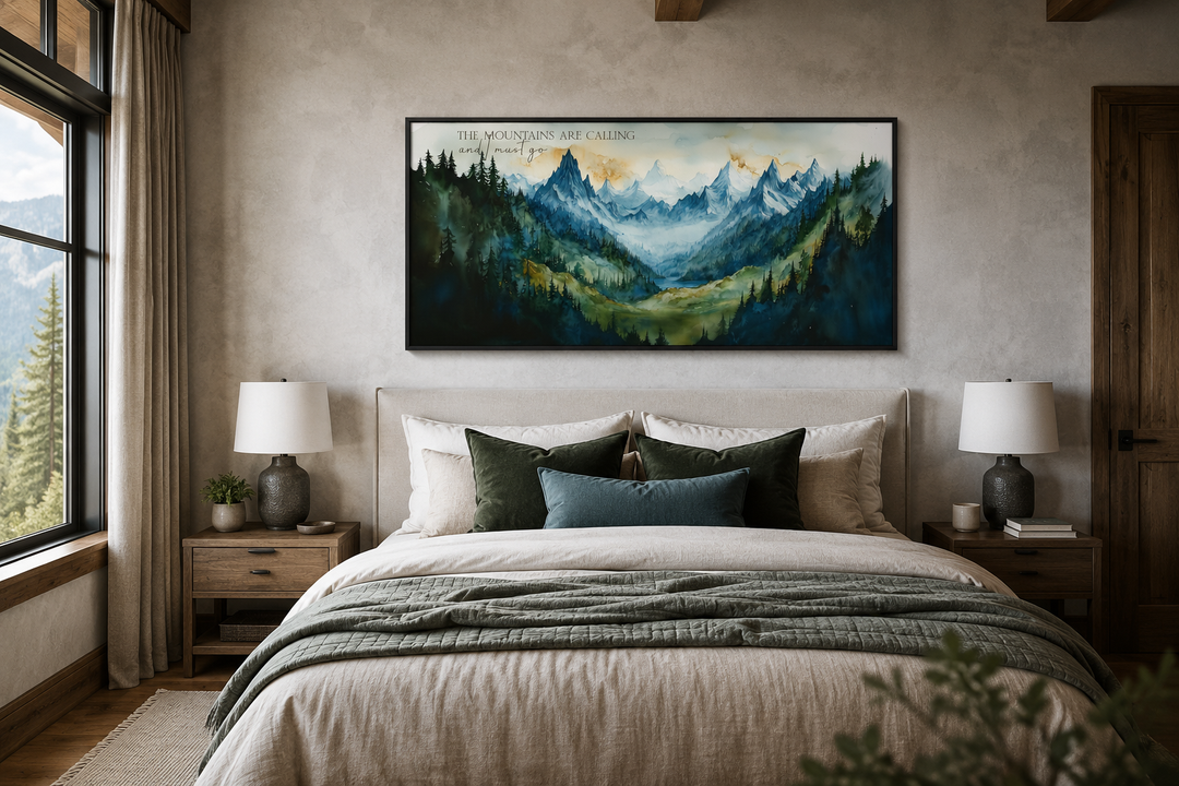 Framed watercolor mountain landscape wall art with quote above a bed in a rustic cabin bedroom.