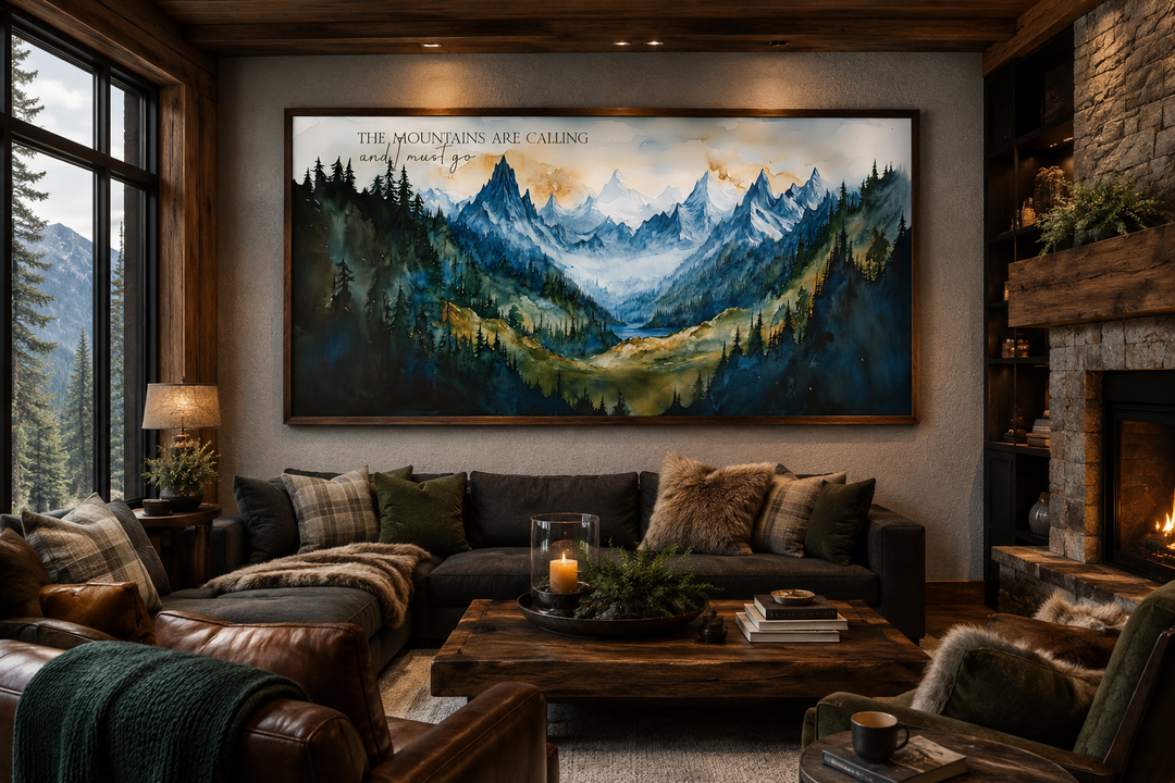 Framed watercolor mountain landscape wall art with quote above a sofa in a rustic cabin living room.