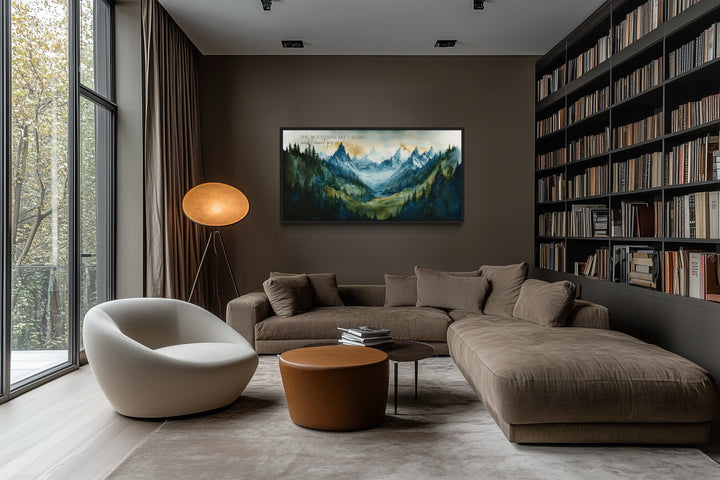 Framed mountain landscape wall art with inspirational quote above a brown sectional sofa.