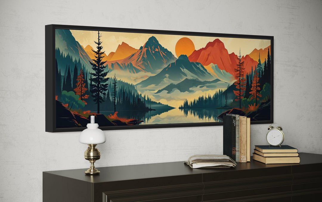 Horizontal mid-century modern canvas wall art of a mountain landscape above a dark wood sideboard.