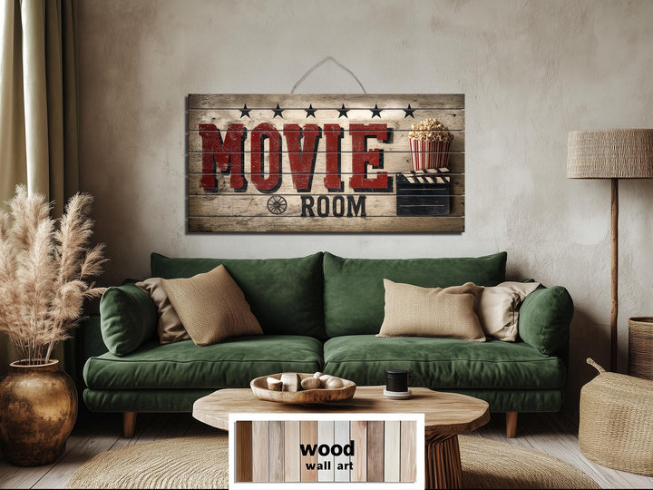 Rustic wood sign wall art with distressed Movie Room print hanging above a green sofa.