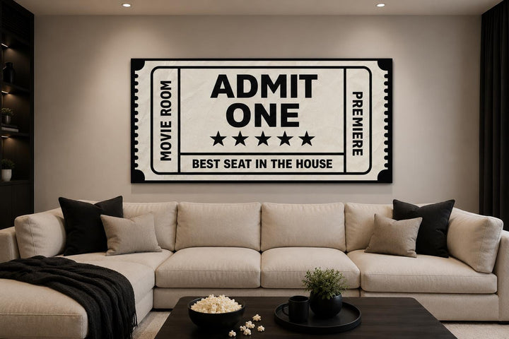 Vintage-style movie ticket canvas wall art above a beige sectional sofa in a home theater room.