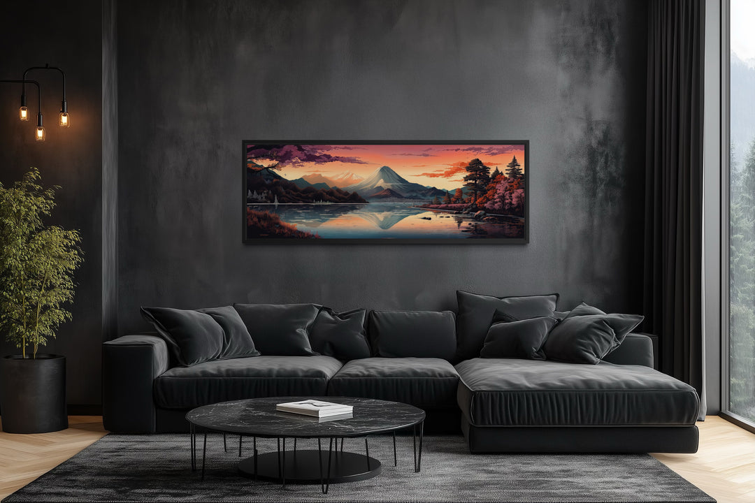 Horizontal framed canvas of Mt. Fuji and Lake Kawaguchiko above a black sofa in a modern room.