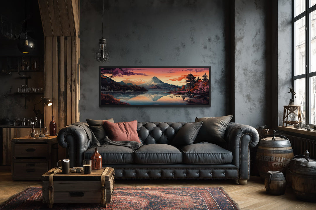 Horizontal framed canvas of Mt. Fuji and Lake Kawaguchiko hanging above a black leather sofa.
