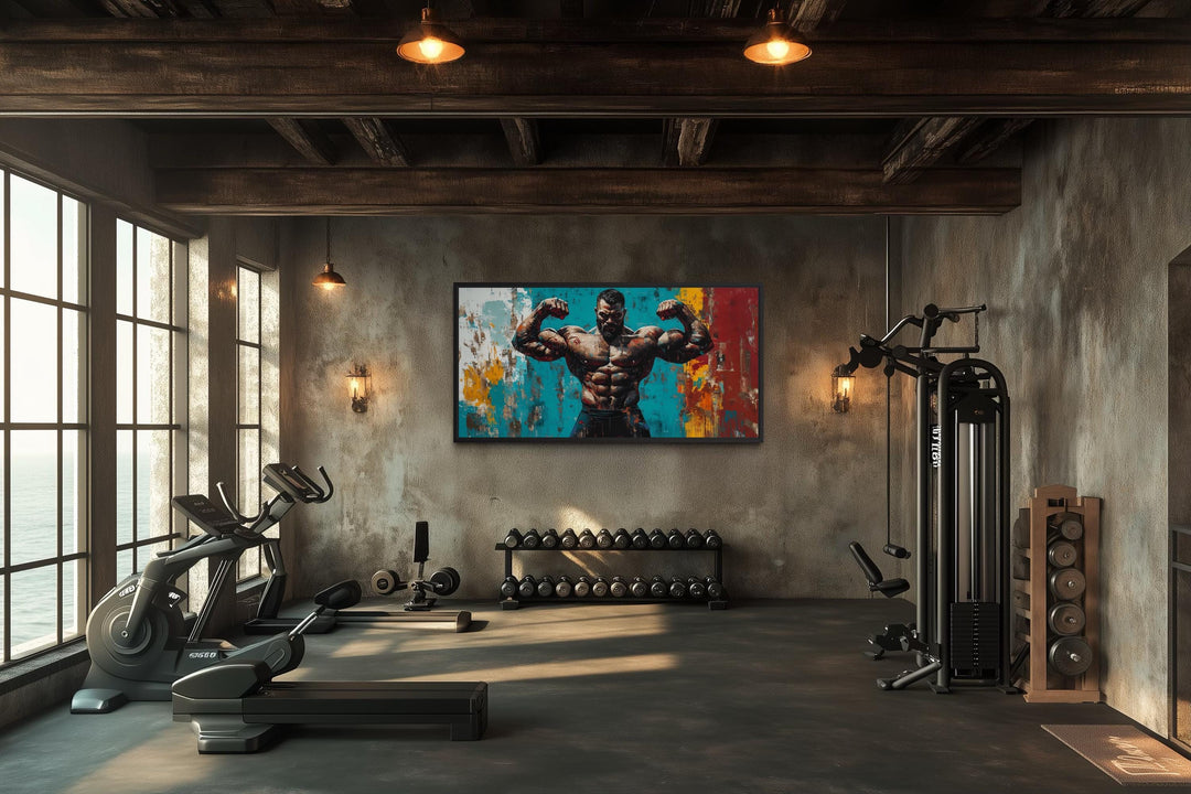 A bold canvas print of a muscular man flexing, displayed in a modern industrial home gym.