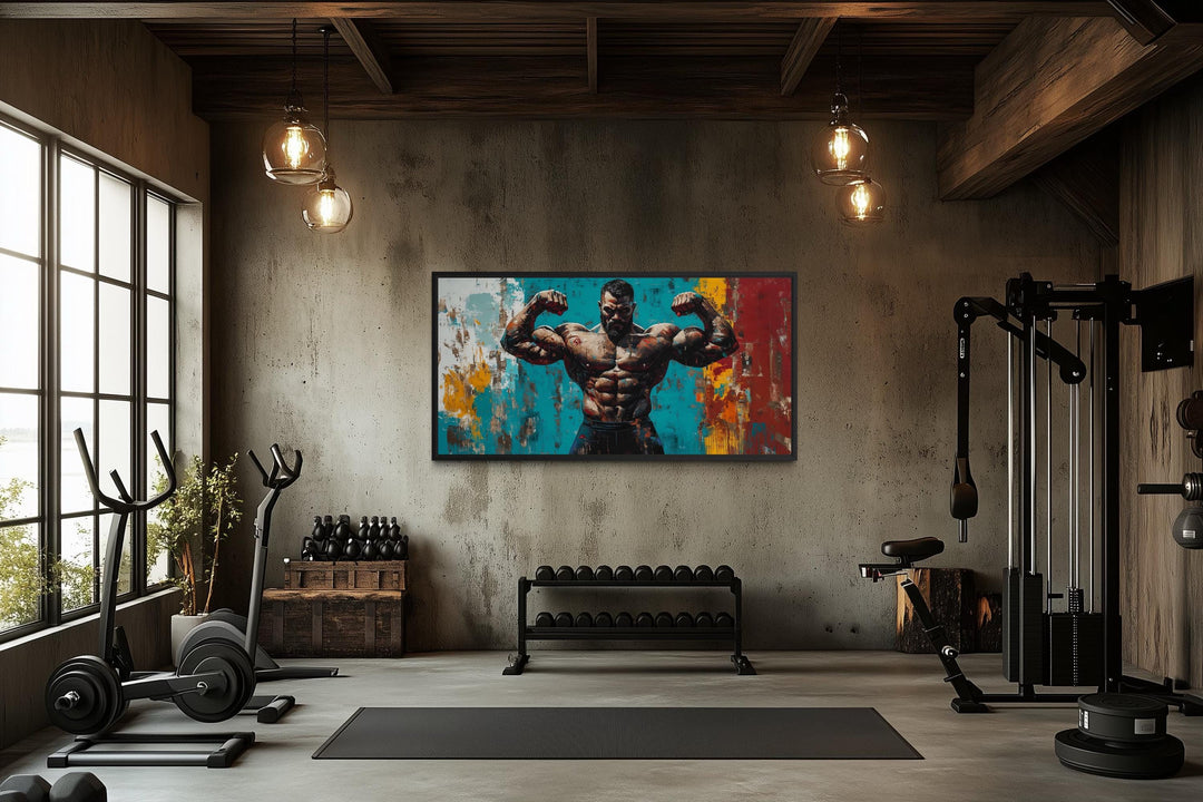 A framed canvas of a muscular man flexing hangs in a modern, industrial-style home gym.