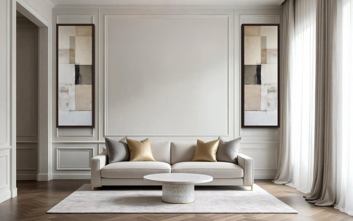 A pair of tall, narrow geometric abstract canvas prints in neutral tones on a light paneled wall.