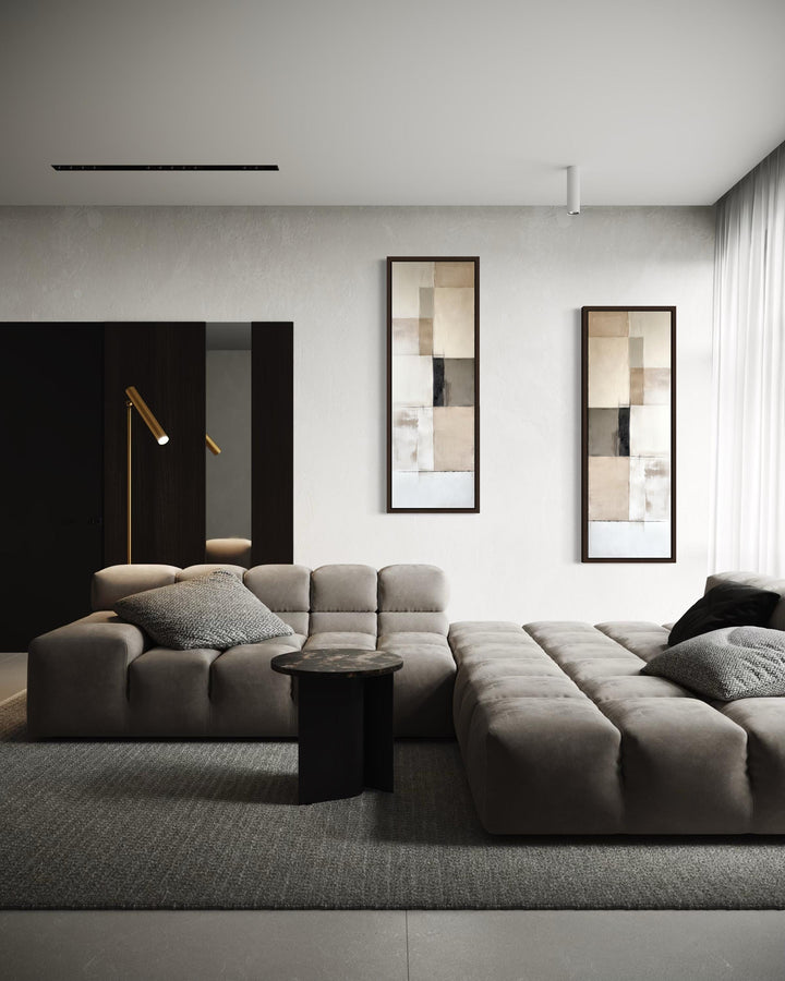 Two tall, narrow abstract canvas prints with neutral geometric blocks in a modern living room.