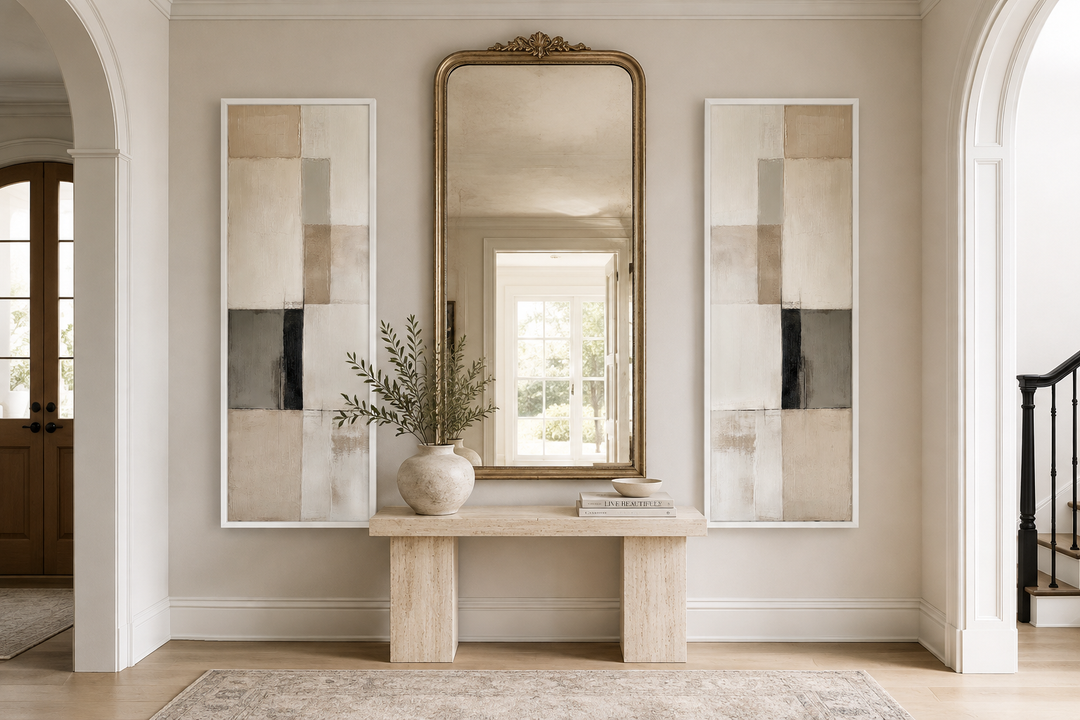 Narrow geometric neutral abstract set of 2 canvas wall art flanking a gold mirror in an entryway.