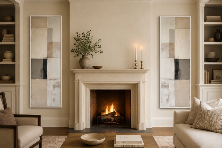 Two tall, narrow abstract canvas prints with neutral geometric blocks flanking a stone fireplace.