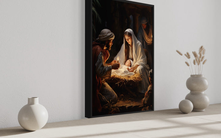 Framed canvas art depicting the Nativity scene with Mary, Joseph, and baby Jesus.