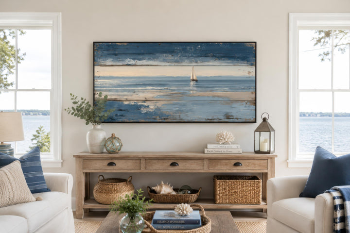 Lone sailboat canvas print with a distressed wood look above a rustic wooden console table.
