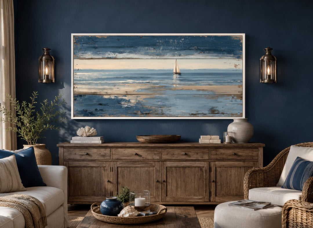 Nautical wall art featuring a lone sailboat canvas print with a distressed wood look on a blue wall.