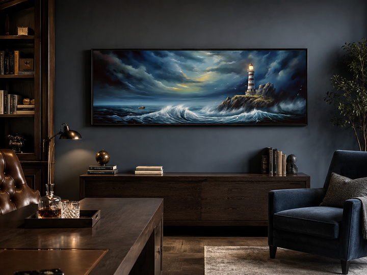 Dramatic long horizontal wall art of a lighthouse in a stormy ocean above a dark wood sideboard.