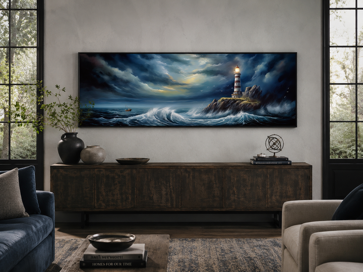 Dramatic lighthouse in stormy ocean long horizontal wall art hanging above a dark wood sideboard.