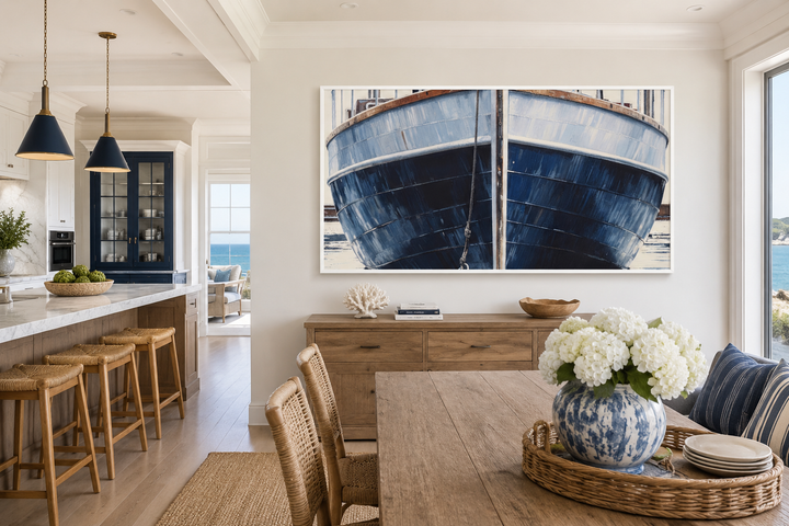 Large framed canvas wall art of a navy blue rustic boat hull in a coastal dining room.