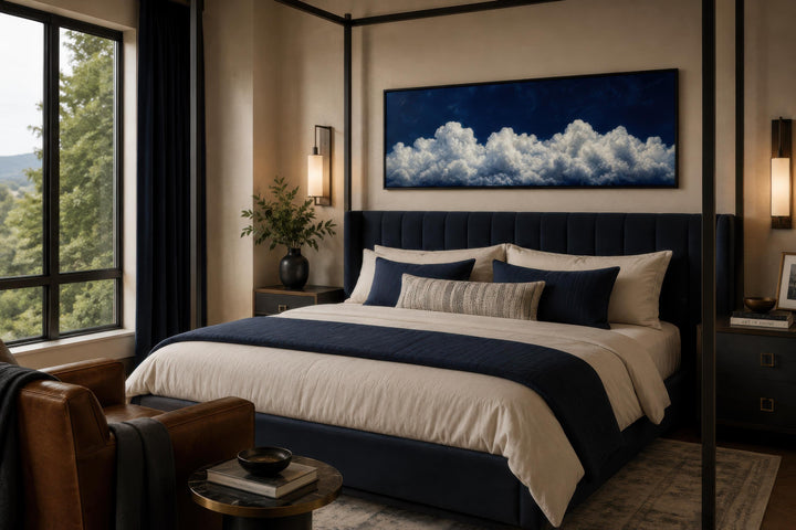 Navy blue cloud wall art canvas print displayed above a bed in a modern bedroom.