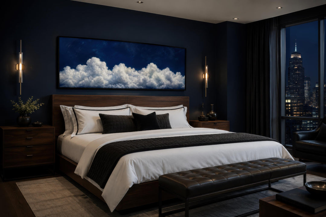 Navy blue cloud wall art canvas print hanging above a bed in a modern dark-toned bedroom.