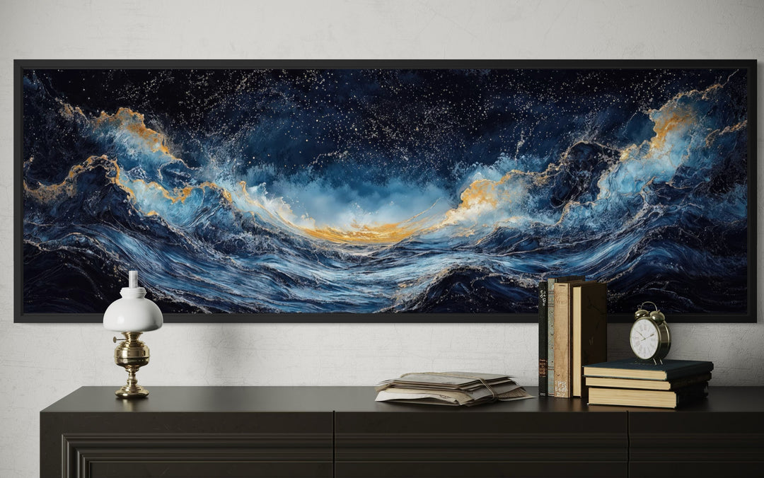 Navy blue and gold ocean wave horizontal canvas wall art framed above a dark console table.