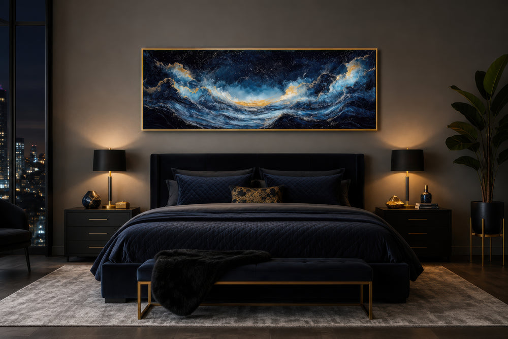 Navy blue and gold ocean wave horizontal canvas wall art hanging above a dark blue velvet bed.