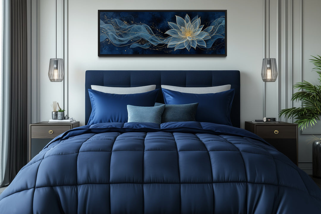 Navy blue and gold minimalist lotus flower canvas wall art hanging above a bed in a modern bedroom.