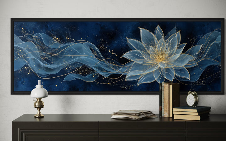 Navy blue and gold minimalist lotus flower canvas wall art above a dark wood console table.