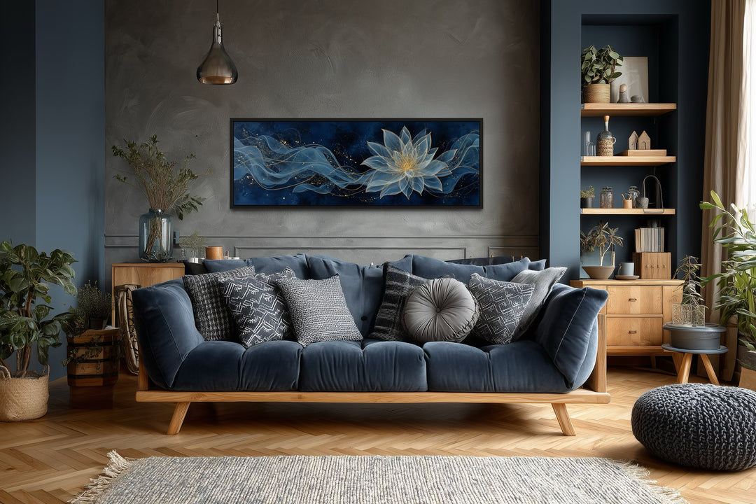 Navy blue and gold minimalist lotus flower canvas wall art hanging above a blue sofa.
